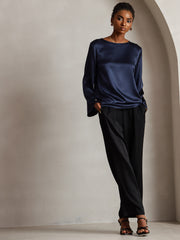 Navy 19Momme mulberry silk bell sleeve boat neck women's top with black pants.