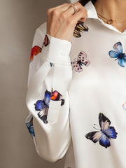 White 19Momme mulberry silk butterfly print long sleeve women's shirt with a lapel collar.
