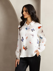 White 19Momme mulberry silk women's shirt with colorful butterfly print, long sleeves, and lapel collar.