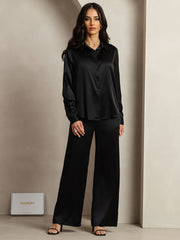 Women's black mulberry silk button-up shirt and wide-leg pants set.