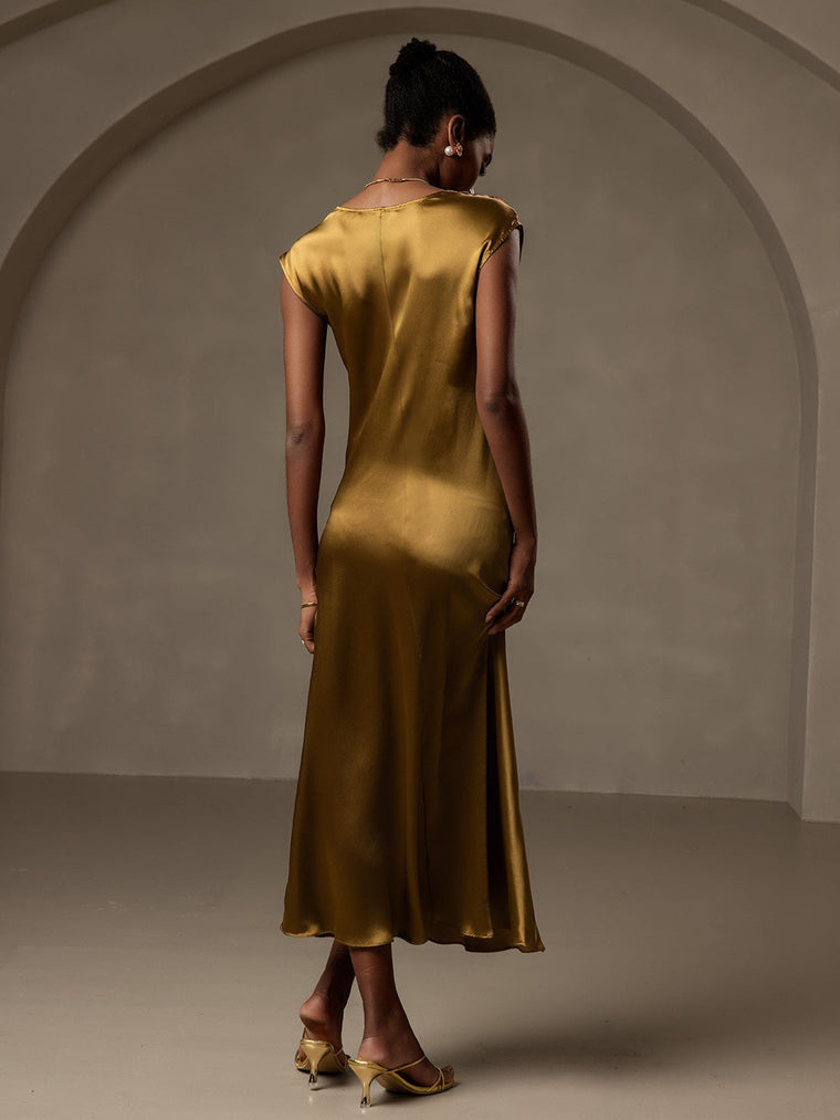 Woman in a gold 19Momme mulberry silk cap sleeve round neck midi dress.