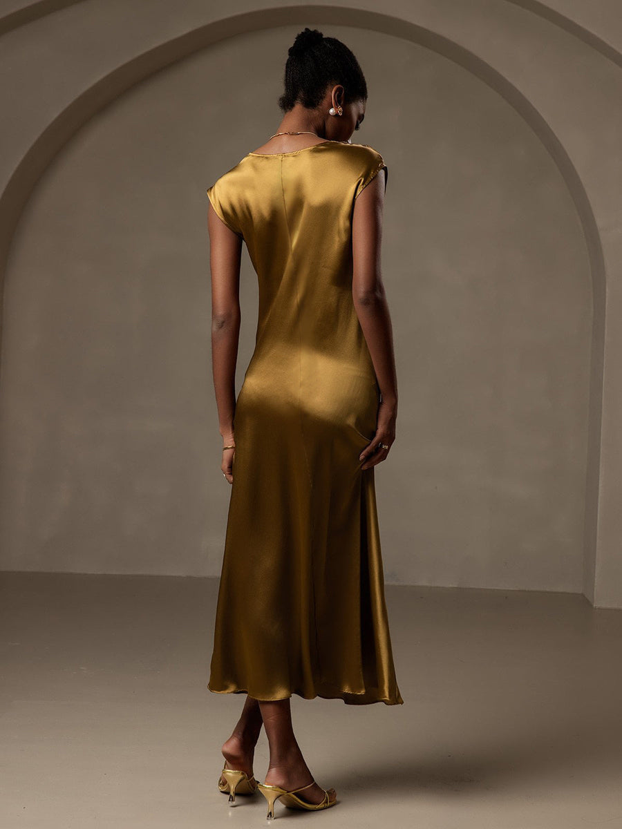 Woman in a gold 19Momme mulberry silk cap sleeve round neck midi dress.