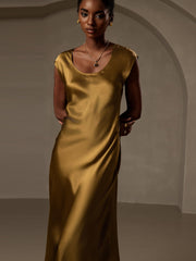 Woman in a luxurious gold 19Momme mulberry silk cap sleeve round neck midi dress.