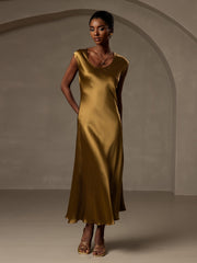 Woman in a luxurious gold 19 Momme mulberry silk cap sleeve round neck midi dress.