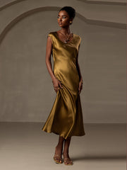 Woman in a 19Momme mulberry silk cap sleeve round neck midi dress in a rich golden hue.
