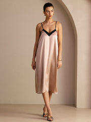 Women's 19 Momme mulberry silk midi dress in blush pink with black contrast V-neck and spaghetti straps.