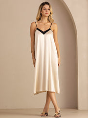 Women's 19Momme mulberry silk midi dress in cream with black contrast V-neck and spaghetti straps.