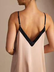 Women's 19Momme mulberry silk midi dress in blush with black contrast V-neck and spaghetti straps.