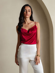 Red 19Momme mulberry silk cowl neck camisole top on a woman, paired with white pants.