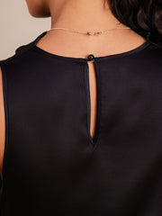 Back of black mulberry silk cowl neck sleeveless short dress with button closure.