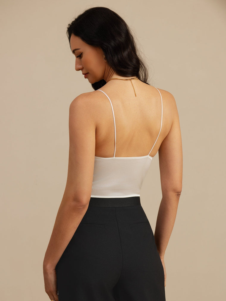 White 19 Momme mulberry silk crop top with spaghetti straps and V-neck, worn by a woman from behind.