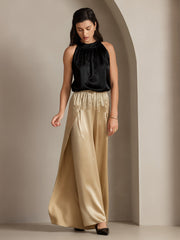 Women's fashionable black silk top and flowy gold mulberry silk high-slit palazzo pants.