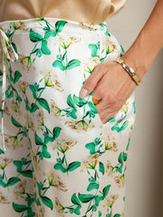 Women's 19 Momme mulberry silk green floral print wide leg pants with side pockets.