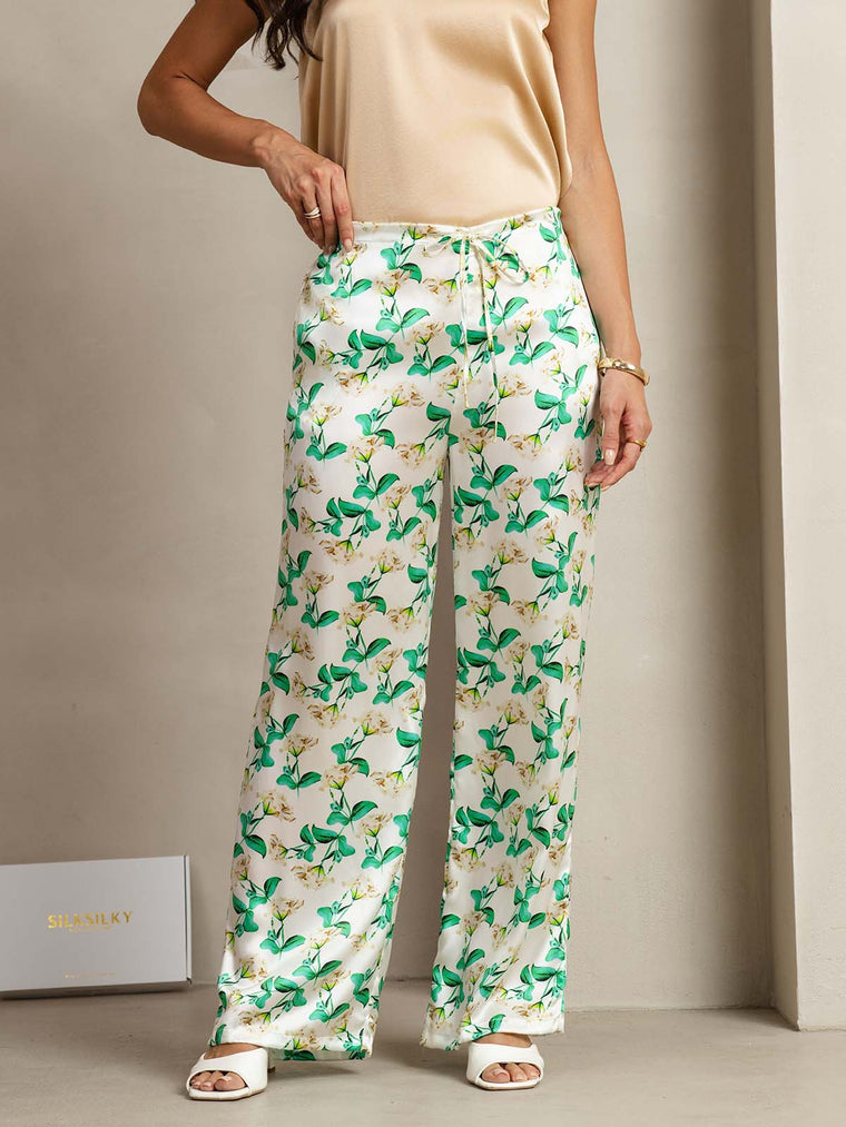 Women's 19Momme silk green floral print wide-leg pants with side pockets.