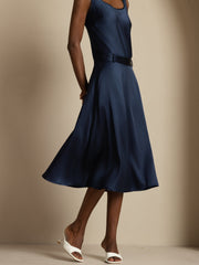 Woman wearing a navy 19Momme mulberry silk high-waist A-line midi skirt with pockets and matching top.