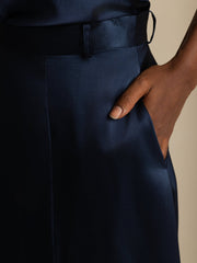 Navy blue 19Momme mulberry silk high-waist A-line midi skirt with a hand in the pocket.