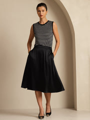 Black 19Momme mulberry silk high-waist A-line midi skirt with pockets, worn by a woman.