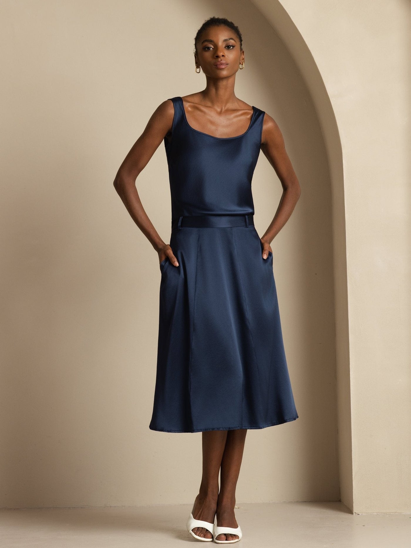 Dark blue 19 Momme mulberry silk high-waist A-line midi skirt with pockets, paired with a matching silk top.