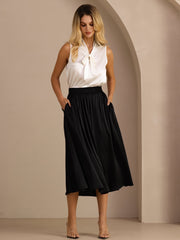 Black 19Momme silk high-waist A-line pleated long skirt with side pockets, paired with a white sleeveless top.