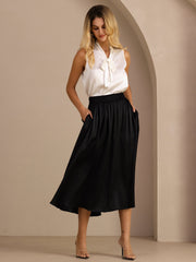 Woman in a black 19Momme mulberry silk high-waist A-line pleated long skirt with side pockets.