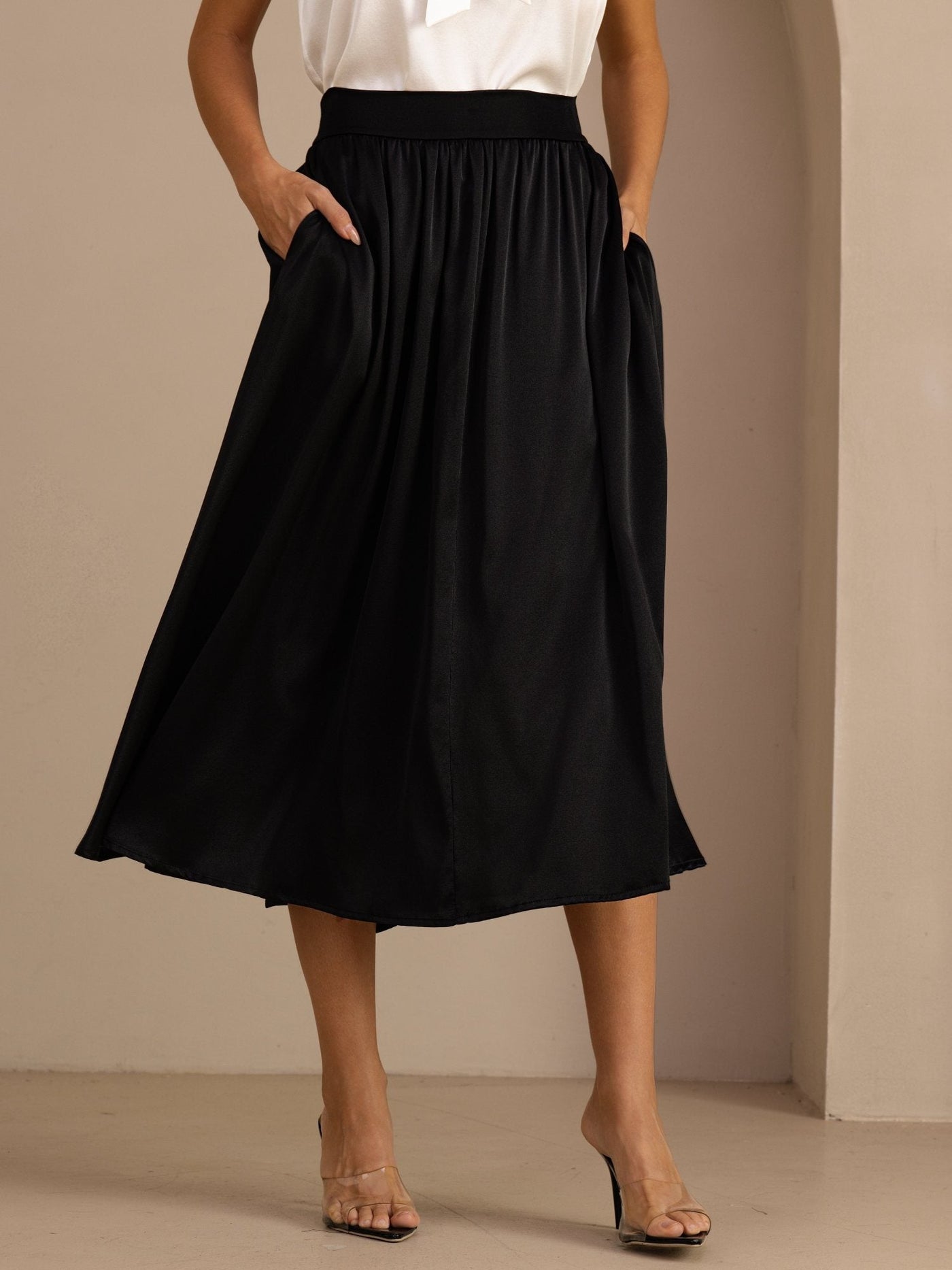 Black 19Momme mulberry silk high-waist A-line pleated long skirt with side pockets.