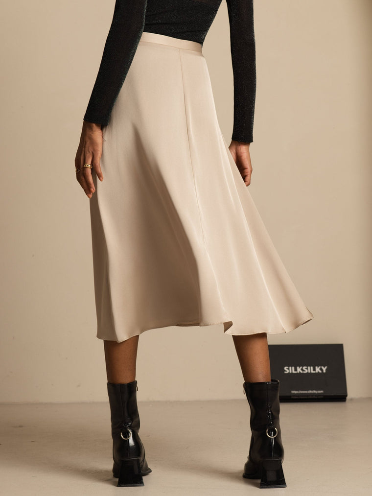 19Momme mulberry silk high-waist A-line midi skirt in champagne with pockets, worn with black top and boots.