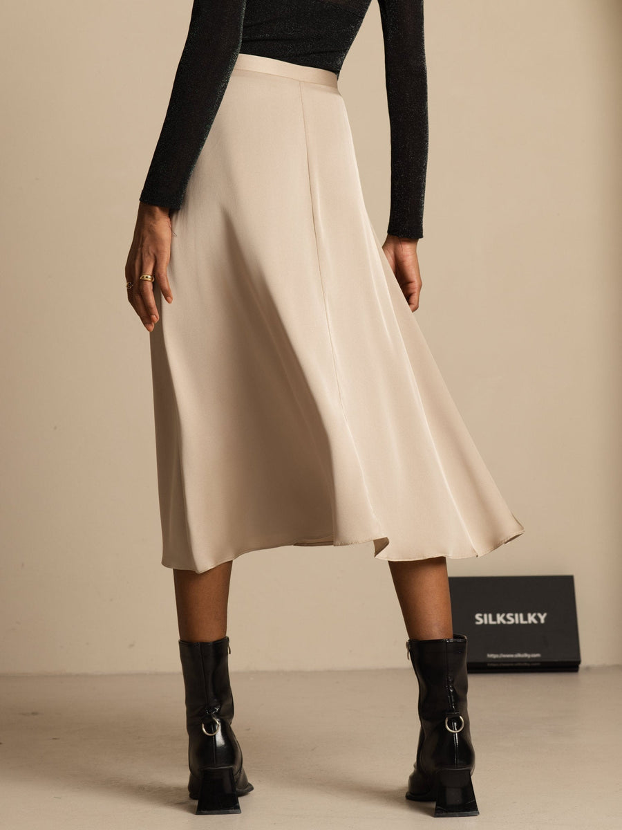19Momme mulberry silk high-waist A-line midi skirt in champagne with pockets, worn with black top and boots.