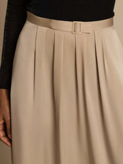 Beige 19Momme silk high-waist A-line pleated midi skirt with a buckle and pockets, worn with a black top.