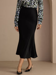 Black 19Momme mulberry silk high waist elegant maxi skirt with a subtle sheen, paired with a patterned blouse.