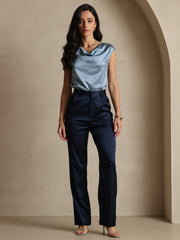 Woman in 19 Momme mulberry silk high waist straight fit navy pants with zipper side pockets and a blue silk top.