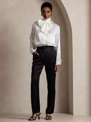 Women's 19 Momme mulberry silk high waist straight fit pants in black with side pockets, paired with a white silk blouse.