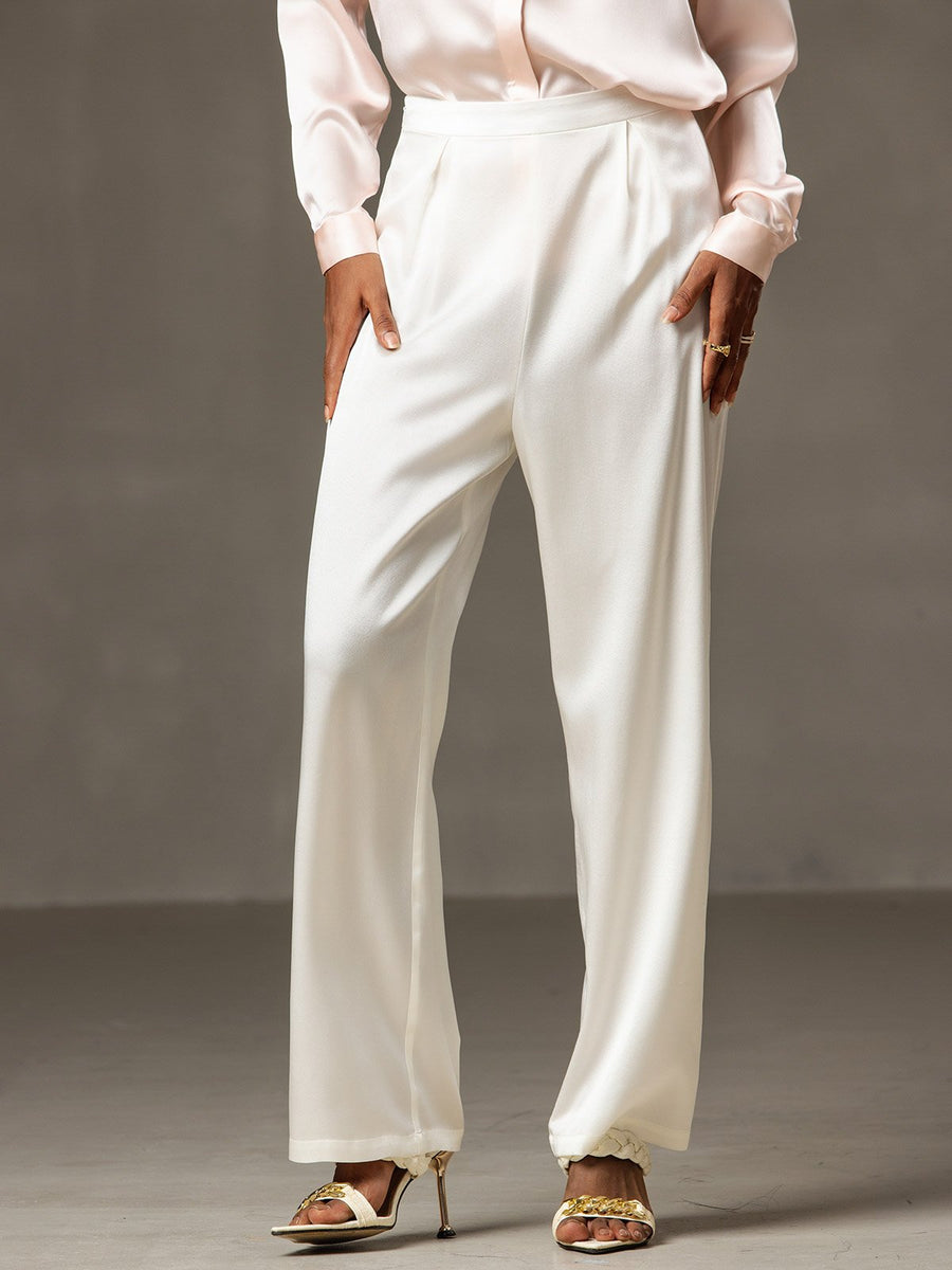 White 19Momme mulberry silk high waist wide leg pleated women's pants with a light pink silk top.