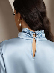 Light blue mulberry silk keyhole neck blouse with pearl buttons and a high ruffled collar.