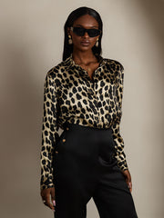 Women's 19Momme mulberry silk leopard print long sleeve lapel collar shirt with black pants.