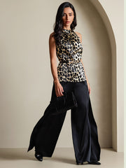 Women's 19Momme silk leopard print sleeveless halter neck top with black wide-leg pants and clutch.