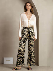 Women's 19 Momme mulberry silk leopard print straight leg pants with side pockets, paired with a cream silk top.