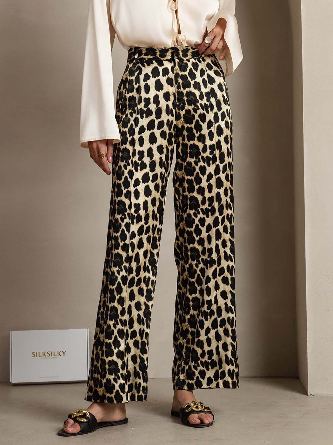 Women's 19 Momme mulberry silk leopard print straight leg pants with side pockets.