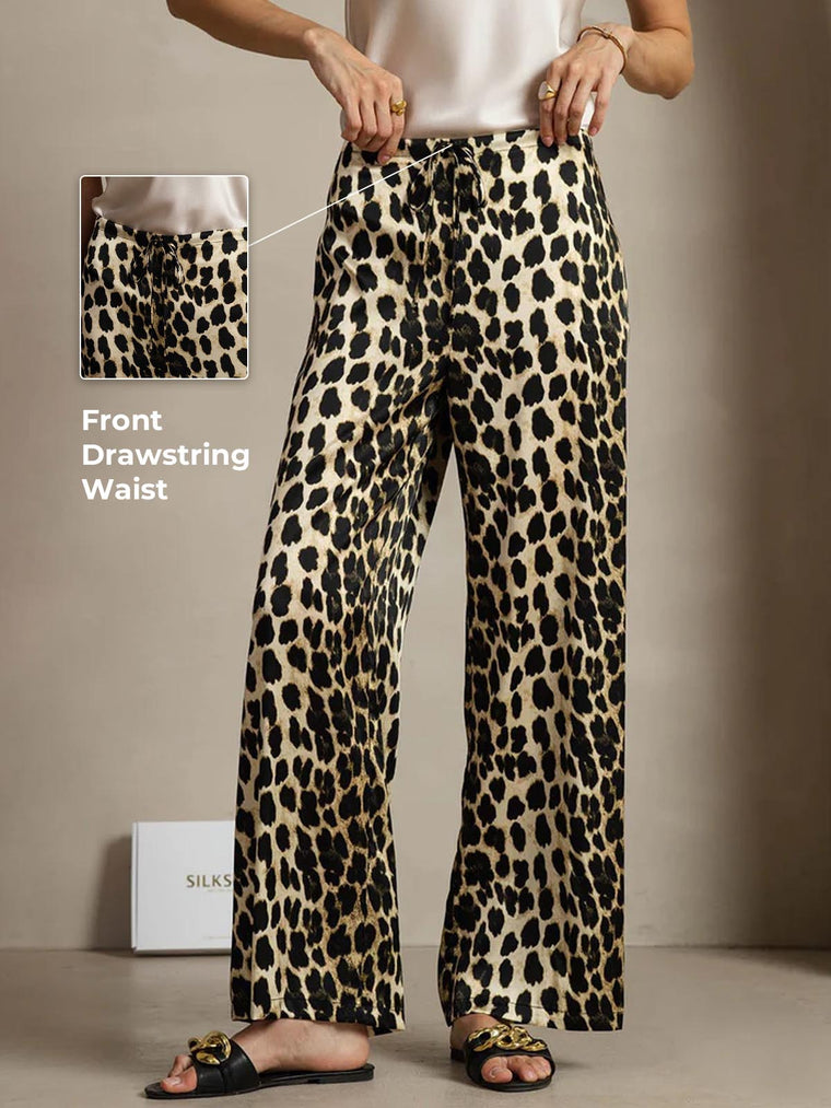 Women's 19 Momme mulberry silk leopard print wide leg pants with a front drawstring waist and side pockets.