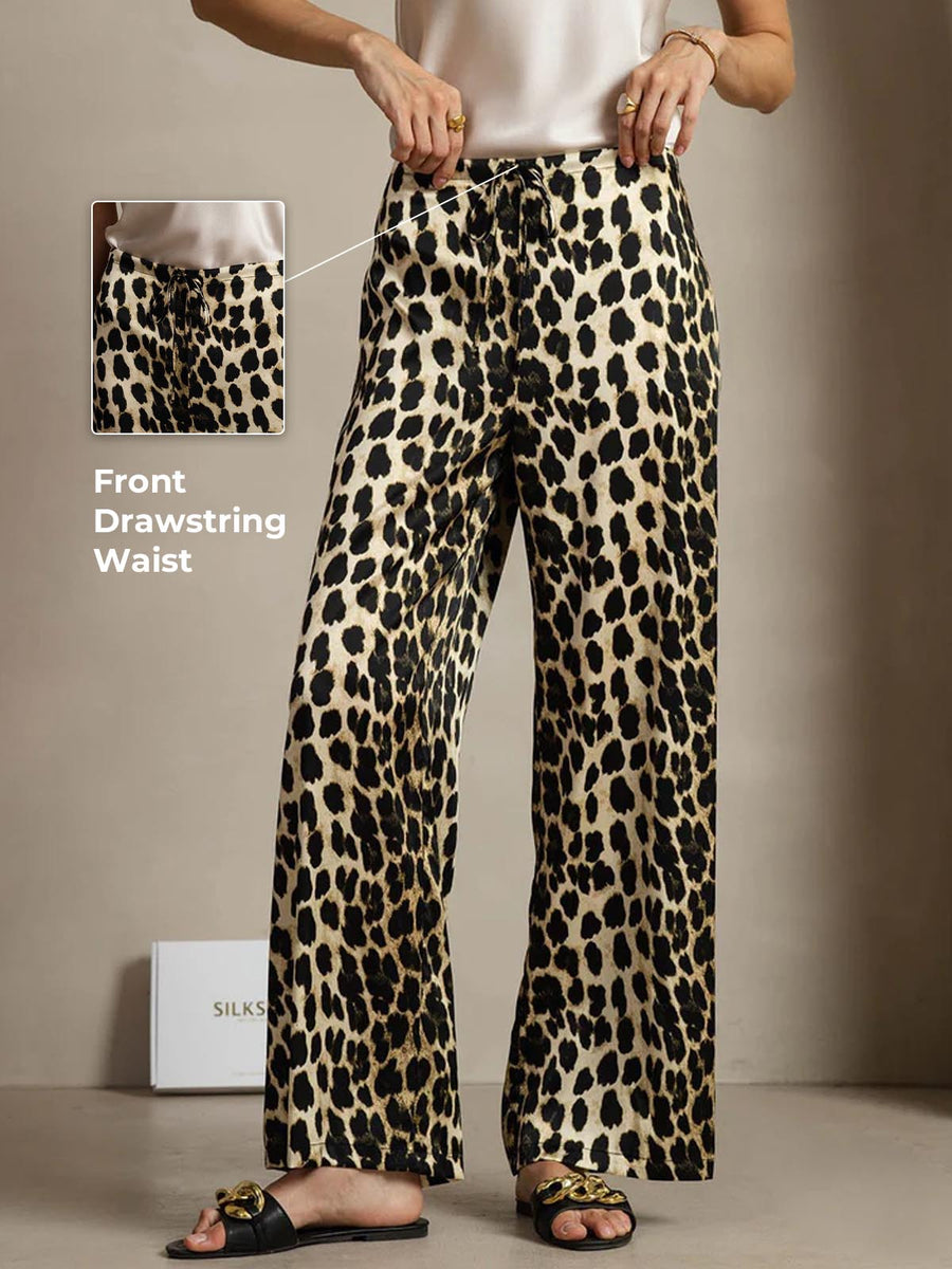 Women's 19 Momme mulberry silk leopard print wide leg pants with a front drawstring waist and side pockets.
