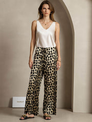Women's 19Momme mulberry silk leopard print wide leg pants with side pockets, paired with a white silk top.