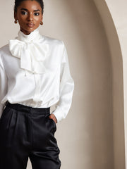 White 19 Momme mulberry silk long sleeve high neck bow tie blouse with black pants.