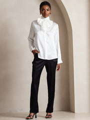 White 19Momme mulberry silk long sleeve high neck bow tie blouse on a woman.