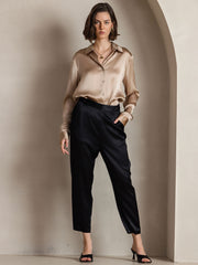 Women's champagne mulberry silk long sleeve lapel collar shirt with black pants.