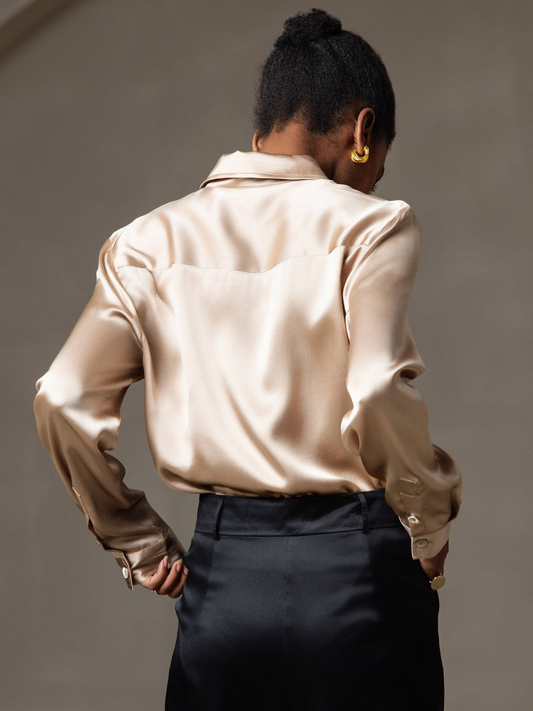 Women's champagne 19Momme mulberry silk long sleeve lapel collar shirt with black pants.