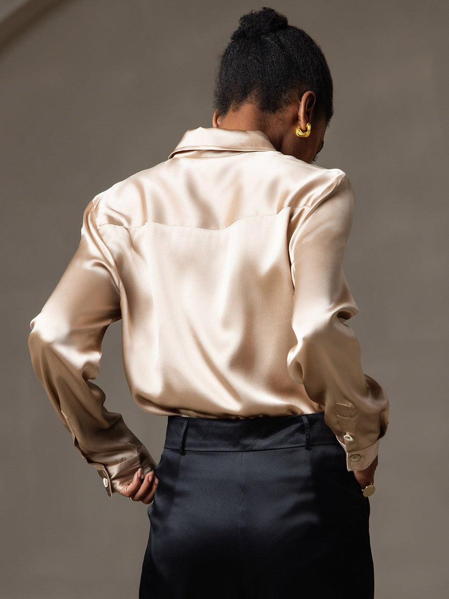 Women's champagne 19Momme mulberry silk long sleeve lapel collar shirt with black pants.