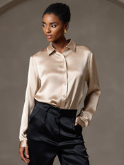 Women's champagne mulberry silk long-sleeve lapel collar shirt with black pants.