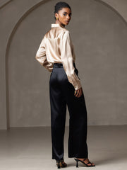 Women's champagne 19Momme mulberry silk long sleeve lapel collar shirt with black pants.