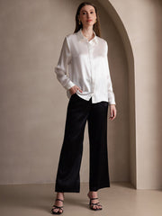 Women's white 19Momme mulberry silk long sleeve lapel collar shirt with black silk pants.