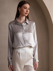 Women's silver 19Momme mulberry silk long sleeve lapel collar shirt with white pants.