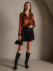 Women's mulberry silk long sleeve lapel collar shirt in rich brown, paired with a black skirt and boots.